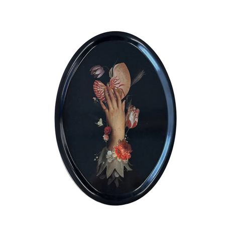 A decorative tray with artistic design of a hand holding a nautilus shell surrounded by flowers on a black background.