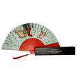 A fortune teller folding fan with a red design when closed, opened to show detailed illustrations. It is displayed next to its black gift box with the museum's name embossed in silver.