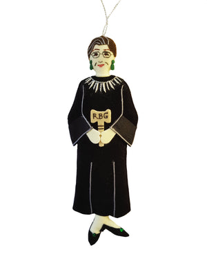 A fabric ornament of Justice Ruth Bader Ginsburg wearing her black robe, white collar, and gavel inscribed with her initials RBG
